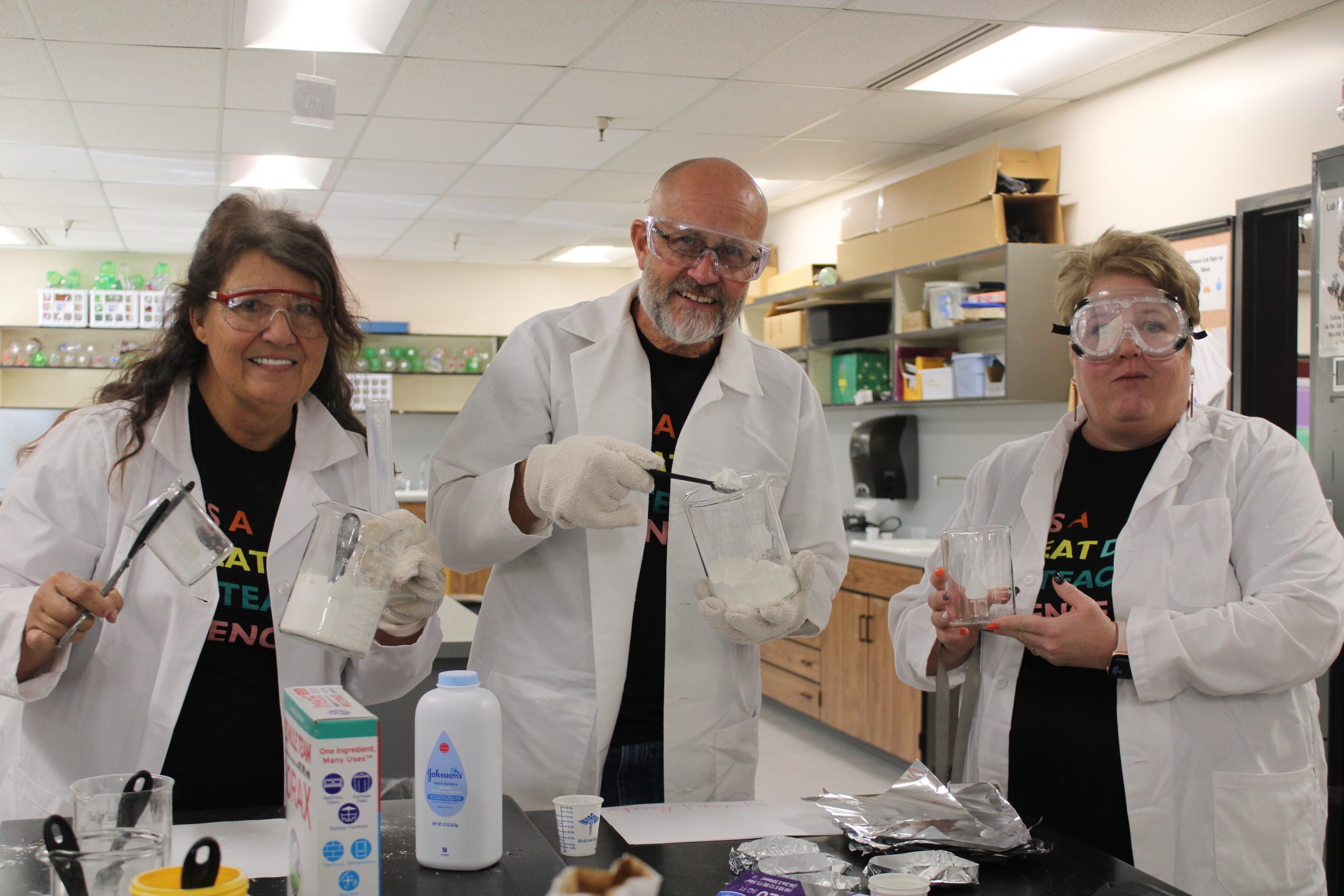 3 science teachers doing and experiment